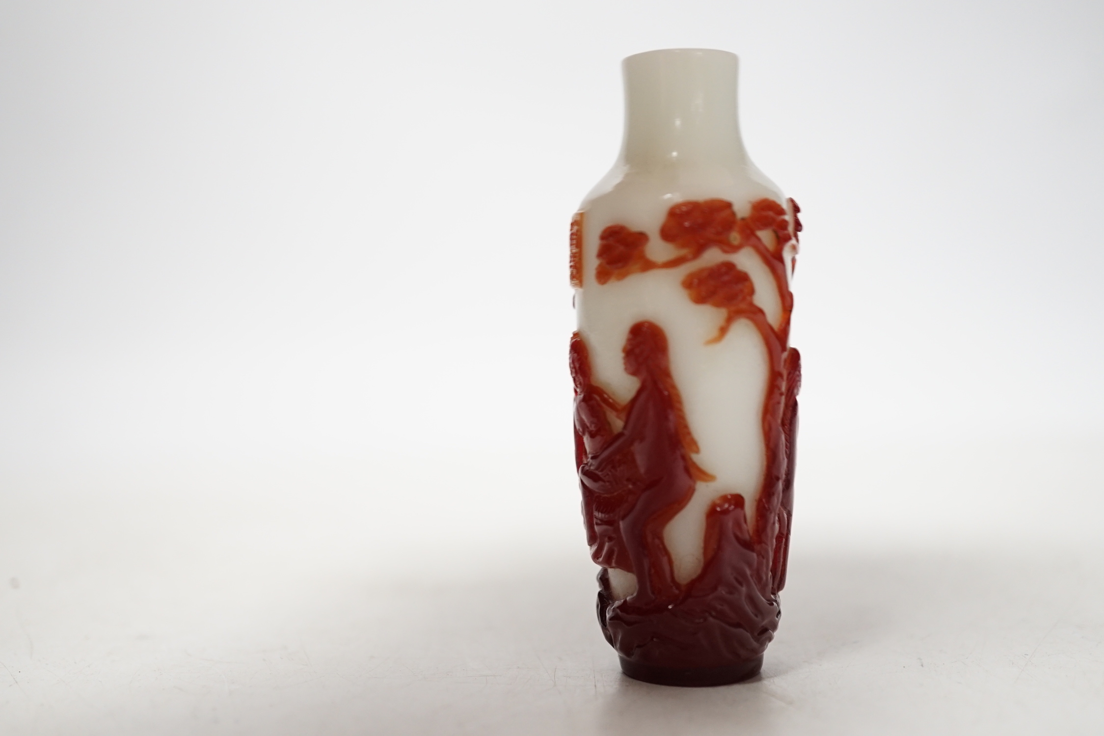 A Chinese ruby and white opaque glass erotic snuff bottle, early 20th century, 8cm high